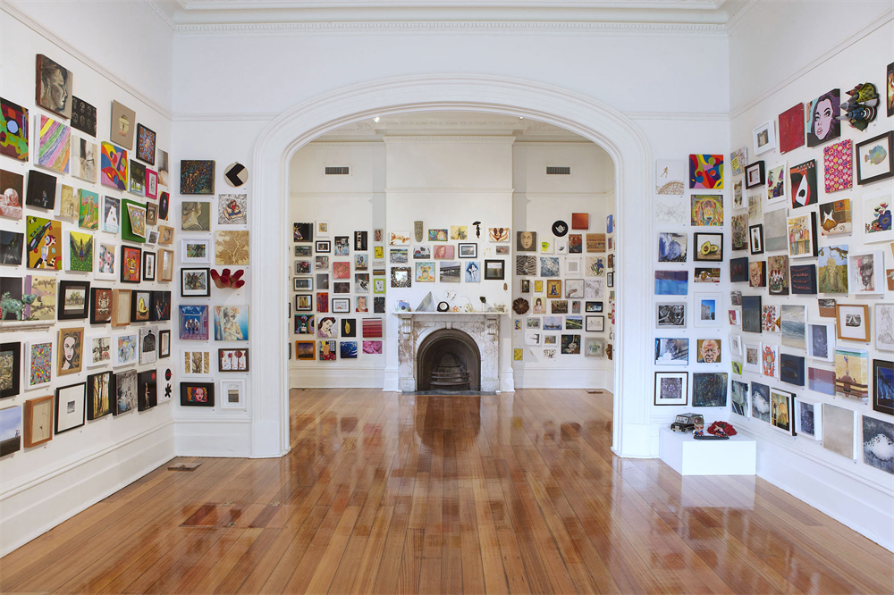 An gallery space with lots of art on the walls